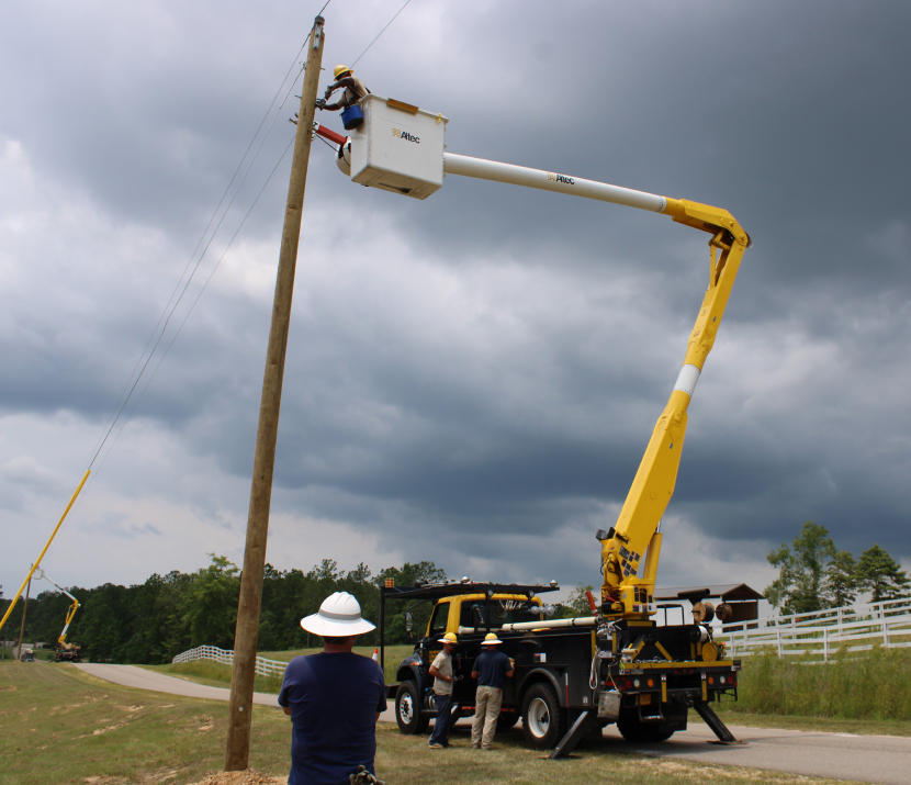 Pearl river Valley lineman crew fixing a power line on a power post